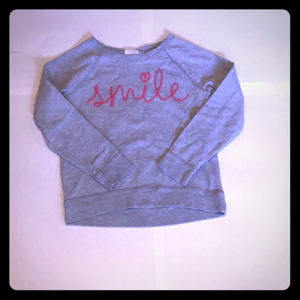 Sweat shirt like shirt says SMILE